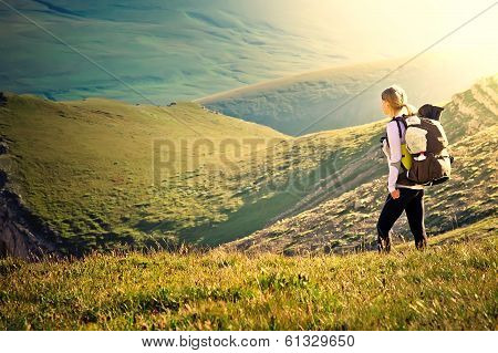 Woman Traveler With Backpack Hiking In Mountains With Beautiful Summer Landscape On Background Mount