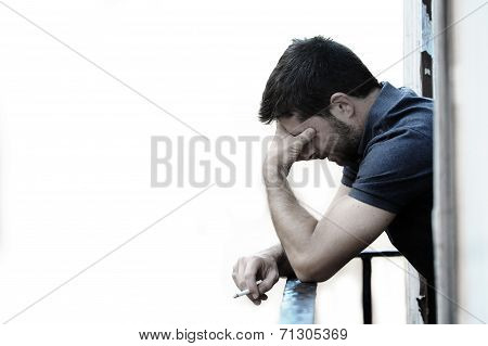 Young Man At Balcony In Depression Suffering Emotional Crisis And Grief