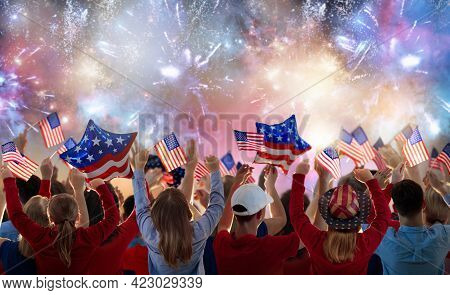 American Family Celebrating 4th Of July. People Watching Independence Day Fireworks Holding Us Flag.