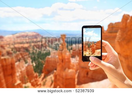 Smartphone camera phone taking photo picture of Bryce Canyon nature. Closeup of mobile phone camera screen photographing beautiful american landscape Bryce Canyon, Utah, USA.