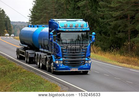 SALO, FINLAND - OCTOBER 22, 2016: Beautiful blue Scania R580 tank truck on rural road flanked by forest. Scanias new truck range wins International Truck of the Year 2017 Award.