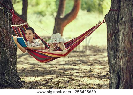 Teenager Girl Lay In Hammock With Book And Kitten Outdoor Summer Garden Photo