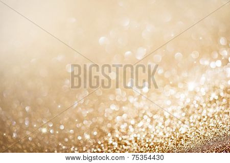 Christmas Background. Golden Holiday glowing Abstract Glitter Defocused Background With Blinking Stars. Blurred Bokeh 