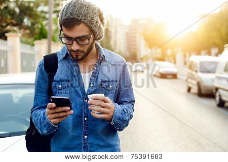 Modern Young Man With Mobile Phone In The Street.