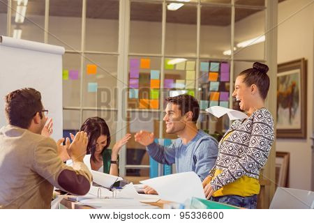 Group of business people celebrating by throwing their business papers in the air