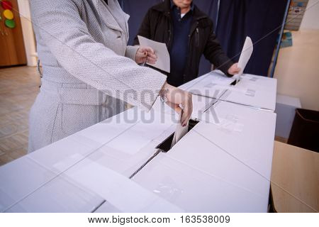 A person casts her ballot during voting for parliamentary elections at a polling station in Bucharest Romania.