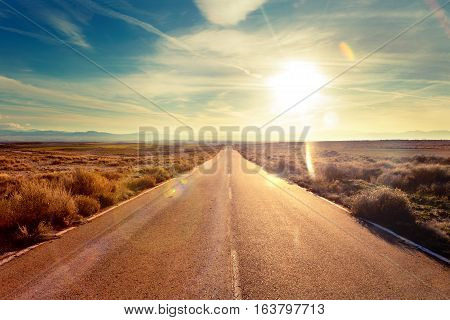 Road through landscape. Road and car travel scenic and sunset. Road travel concept.Car travel adventures.