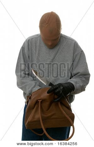 Mugger with a knife searching through a handbag from his latest victim.