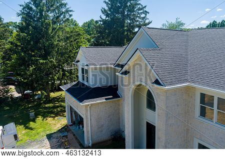 In Building Construction, A New Roof Is Being Installed On A House Roof Covering Asphalt Shingles An