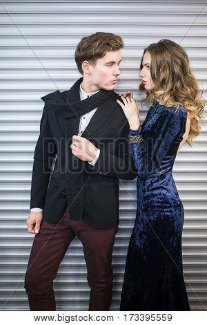 Fashion style photo of a beautiful couple over city background.