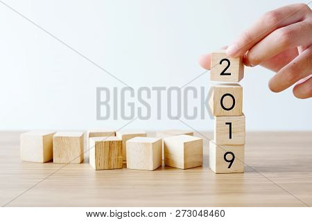 Hand Holding 2019 Happy New Year Wood Cubes On Table Background, 2019 New Year Greeting Card Banner