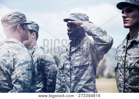 Military trainer giving training to military soldier at boot camp