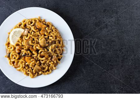 Traditional Spanish Fideua. Noodle Paella On Black Background