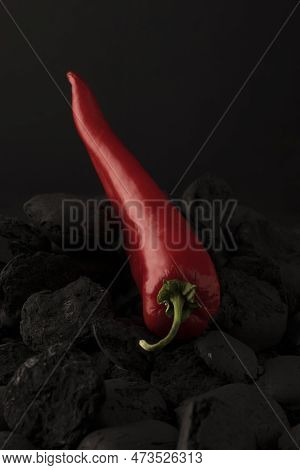 Natural Vegetarian Food. Red Hot Pepper On A Black Charcoal Background. Healthy Food Concept