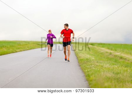 Couple Running On Country Road