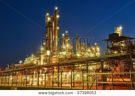 Oil refinery plant of petroleum or petrochemical industry production at sunset