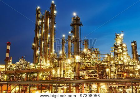 Oil refinery plant of petroleum or petrochemical industry production at sunset