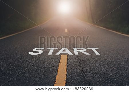 Conceptual image with word start on asphalt road   / Start Your Life