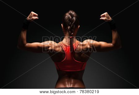 Athletic Young Woman Showing Muscles Of The Back