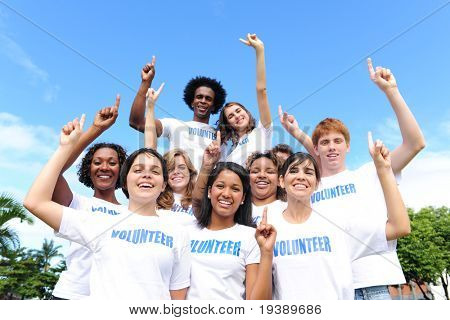 portrait of a happy and diverse volunteer group hands raised