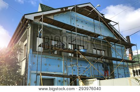 House Building Facade Restoration. Workers On Scaffolding.