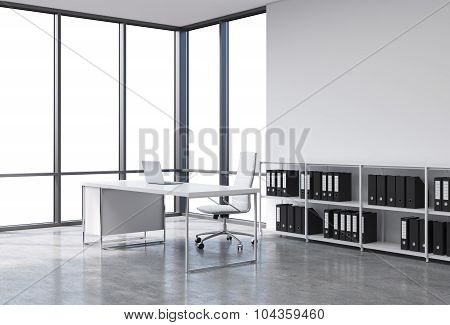 A Workplace In A Modern Corner Panoramic Office With Copy Space In The Windows. A White Desk With A