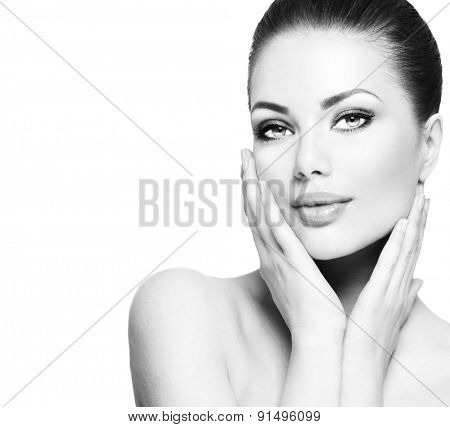 Beauty Portrait. Beautiful Spa Woman Touching her Face. Perfect Fresh Skin. Beauty brunette Model. Youth and Skin Care Concept. Black and white Studio shot