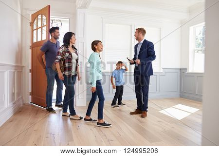 Realtor Showing Hispanic Family Around New Home