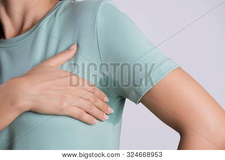 Close-up Asian Woman With Hyperhidrosis Sweating. Young Asia Woman With Sweat Stain On Her Clothes A