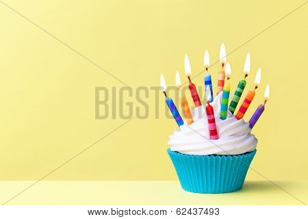 Birthday cupcake against a yellow background