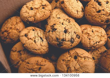 Lots of cookies and biscuits background. Sweet chocolate chips biscuits and cookies texture background. Oatmeal, chocolated drops and other sweets. Dessert, sweets for tea. Fattening sweets concept