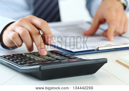 Close up view of bookkeeper or financial inspector hands making report calculating or checking balance. Home finances investment economy saving money or insurance concept