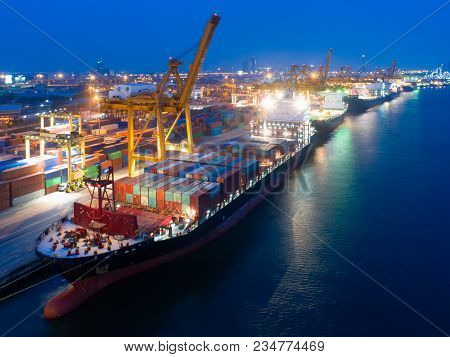 Aerial View Of Business Port With Shore Crane Loading Container In Container Ship In Import/export A