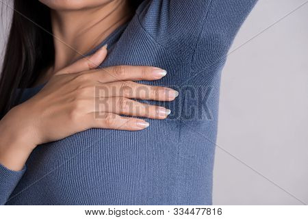 Close-up Asian Woman With Hyperhidrosis Sweating. Young Asia Woman With Sweat Stain On Her Clothes A