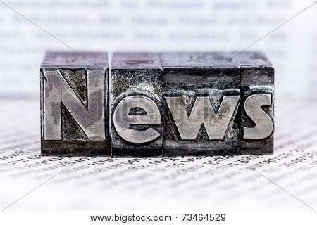 the word news written with lead letters. symbol photo for newsletters, newspapers and information