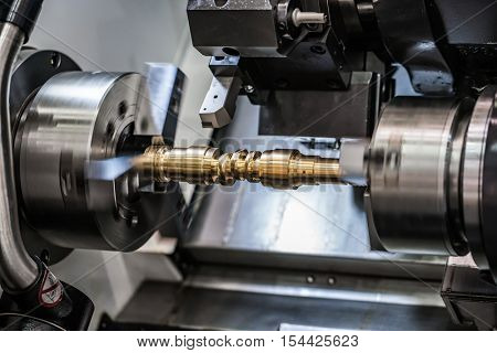 Metalworking CNC milling lathe machine. Cutting metal modern processing technology. Small depth of field. Warning - authentic shooting in challenging conditions. A little bit grain and maybe blurred.