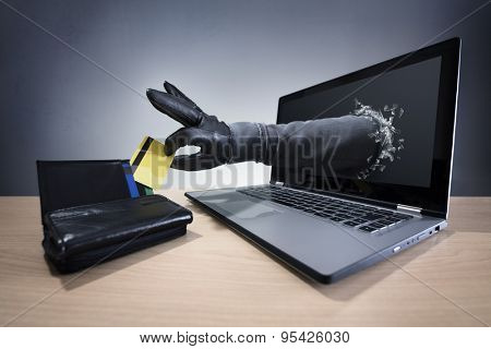 Stealing a credit card through a laptop concept for computer hacker, network security and electronic banking security