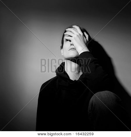 Young woman suffering from severe depression/anxiety  (B&W image)