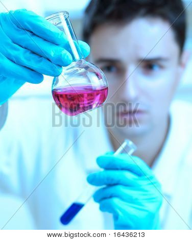 young male researcher carrying out scientific research in a lab