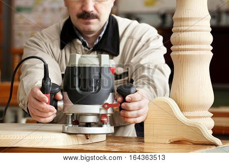 Man doing woodwork in carpentry. Professional woodworker