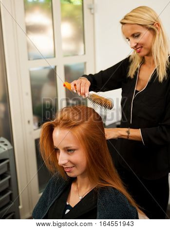 Stylist Drying Hair Of A Female Client At The Beauty Salon - Hairstylist At Work