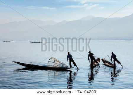 Myanmar travel attraction landmark - Traditional Burmese fisherman at Inle lake, Myanmar famous for their distinctive one legged rowing style