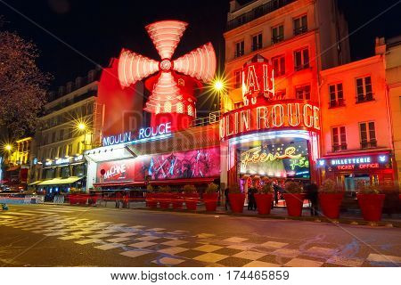 Paris, France - December 28, 2016: The picturesque famous cabaret Moulin Rouge located close to Montmartre in the Paris red-light district of Pigalle on boulevard Clichy at night, Paris, France