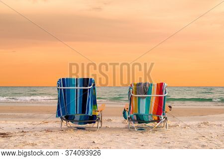 Sunset Beach View Of Beach Lounge Chairs With Towels In Siesta Key Beach Of Florida Gulf Coast, Usa