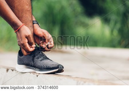 Close Up Asian Sport Runner Black Man Wear Watch Stand Step On The Footpath Trying Shoelace Running 