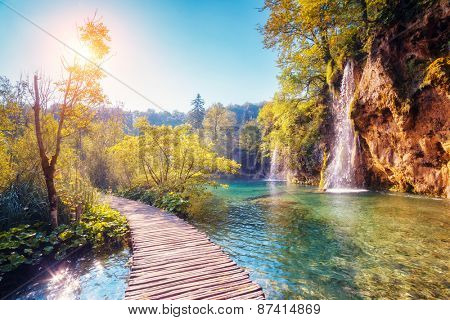 Majestic view on turquoise water and sunny beams in the Plitvice Lakes National Park. Croatia. Europe. Dramatic unusual scene. Beauty world. Retro filter and vintage style. Instagram toning effect.