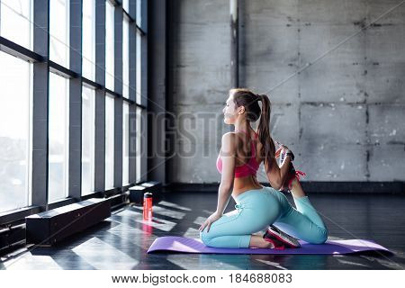 Yoga Mat Woman Stretching Hip, Hamstring Muscles, Leg Muscles With Pigeon Pose Stretch.