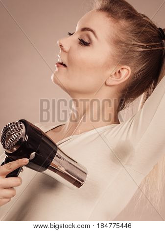 Woman Drying Armpit With Hair Dryer