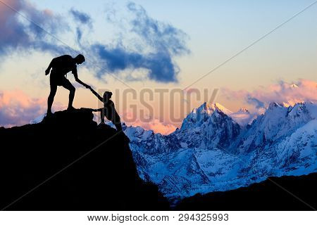 Teamwork Couple Helping Hand, Trust In Mountains. Team Of Climbers Man And Woman Hiking, Help Each O