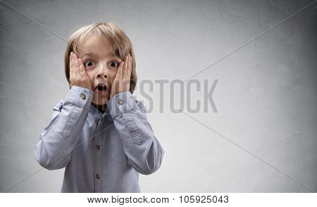 Shocked and surprised boy with copy space concept for amazement, astonishment, making a mistake, stunned and speechless or back to school